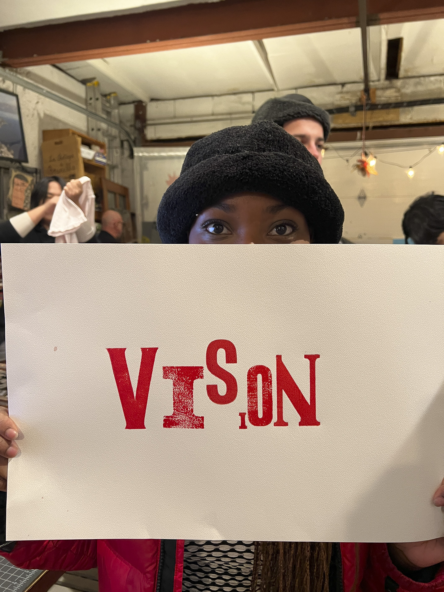 Tisch student holding a print made with hand-set type